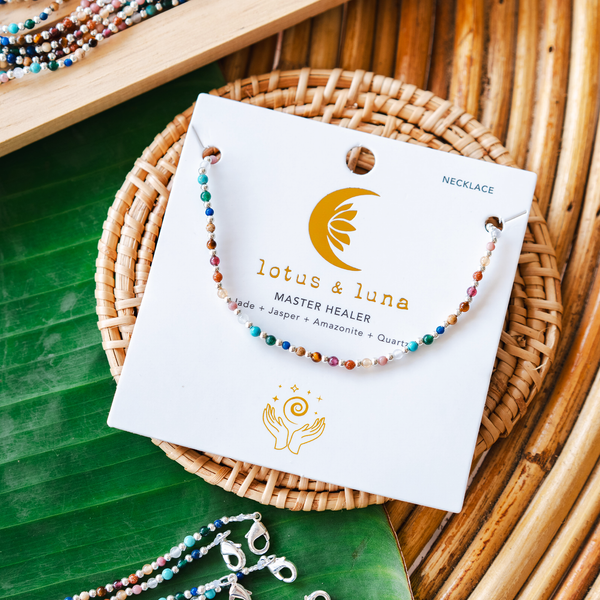 Rainbow stone and gold bead necklace on packaging