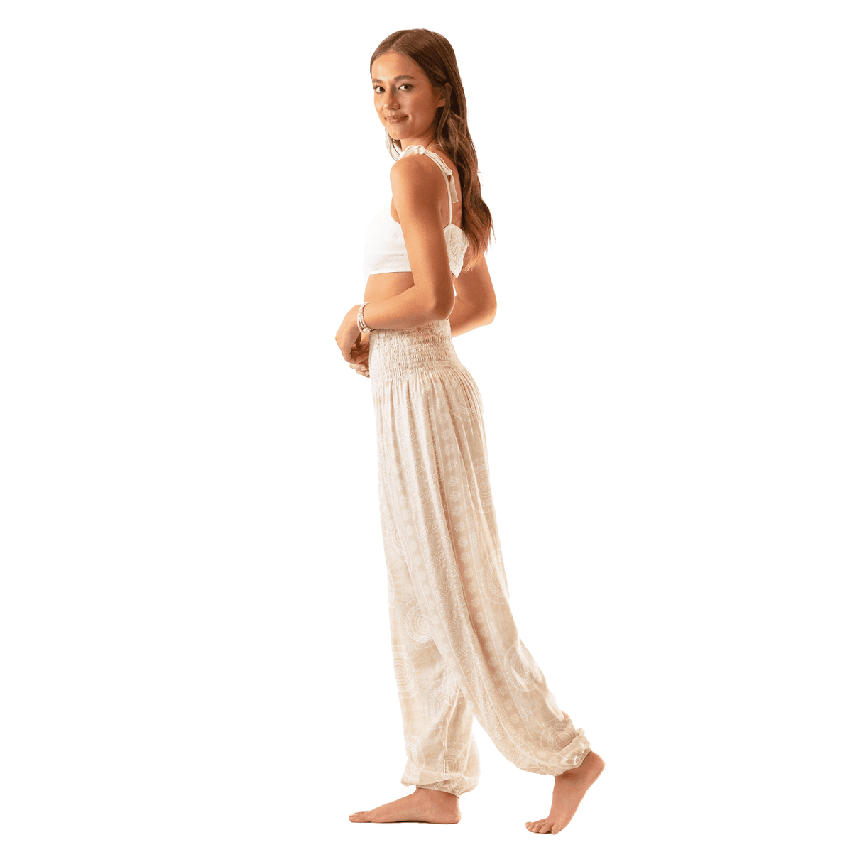 Model wearing cream and white mandala print harem pants