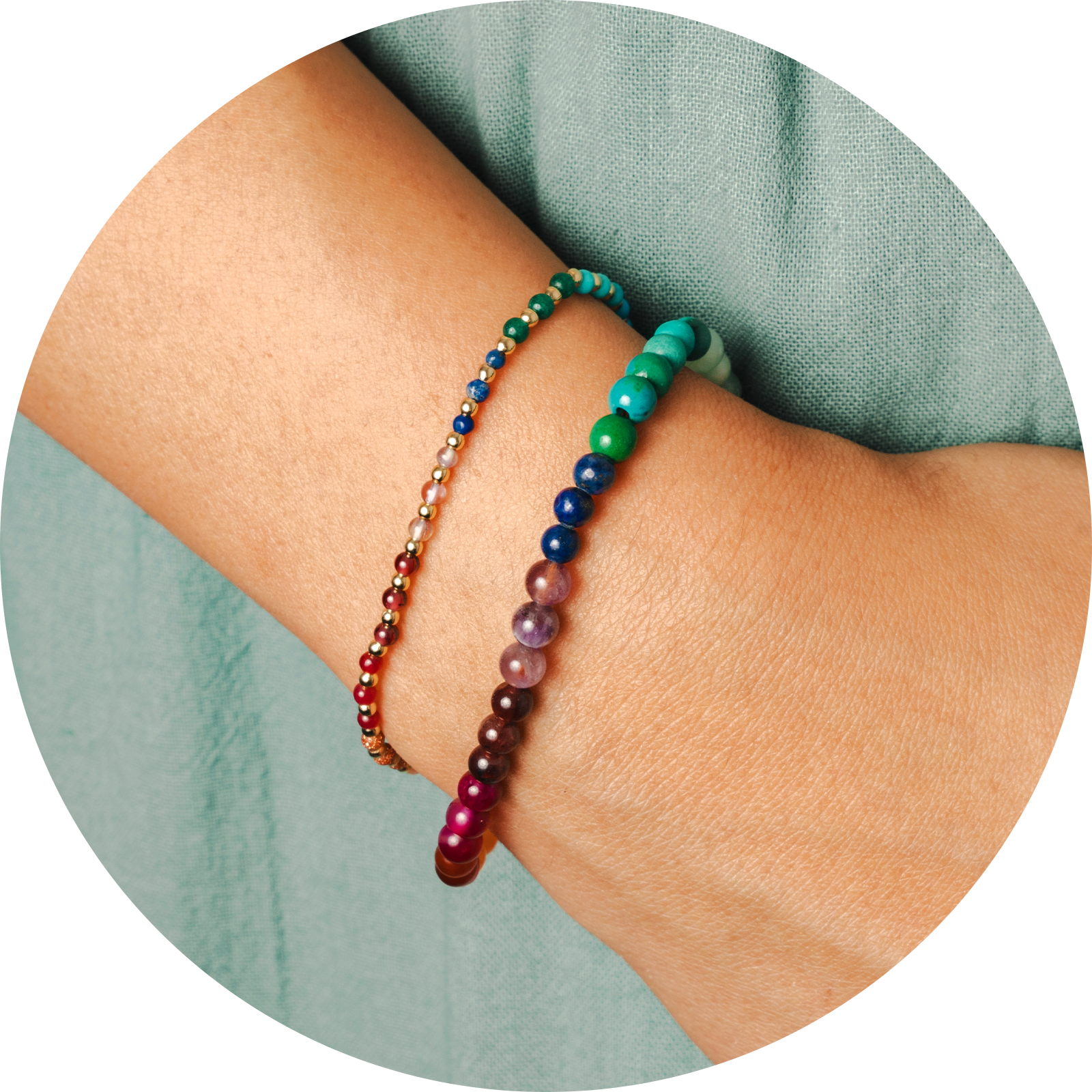 Model wearing a stack of two healing bracelets. Bracelets include a 2mm multicolor stone and gold bead healing bracelet and a 4mm multicolor stone healing bracelet