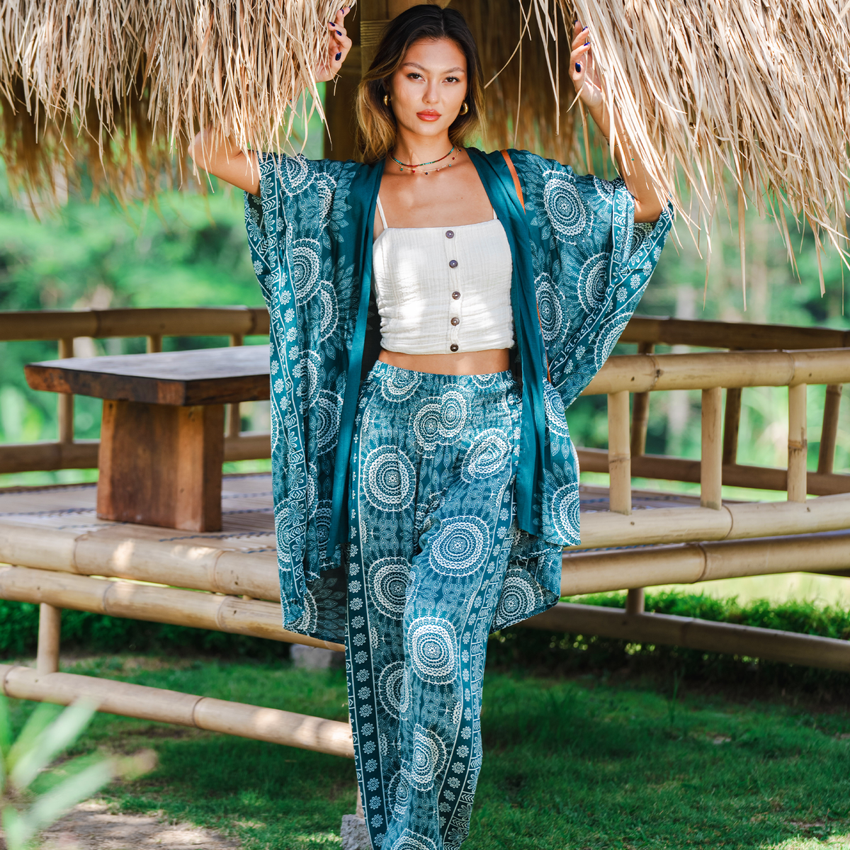 Model wearing verdigris and white mandala print harem pants and a matching kimono