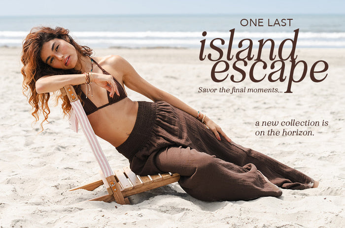 Model is holding a red flower and wearing black maxi skirt