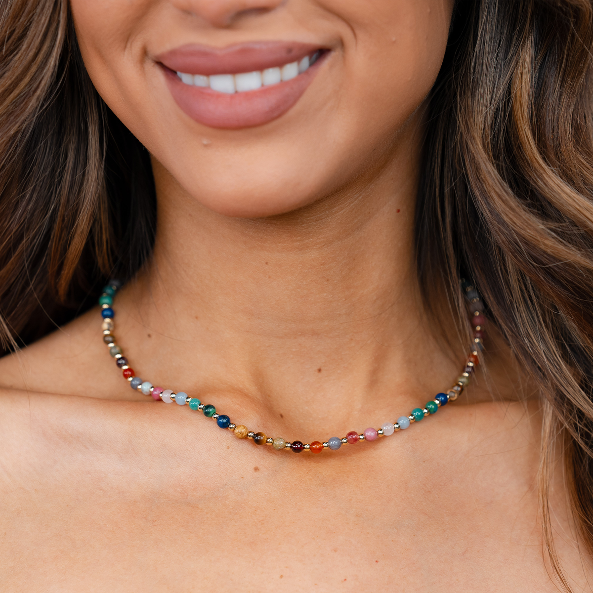 Model wearing a 4mm multicolor stone and gold bead healing necklace