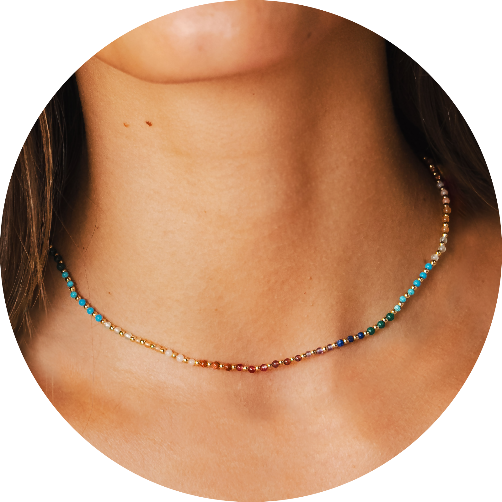 Model wearing a 2mm multicolor stone and gold bead healing necklace