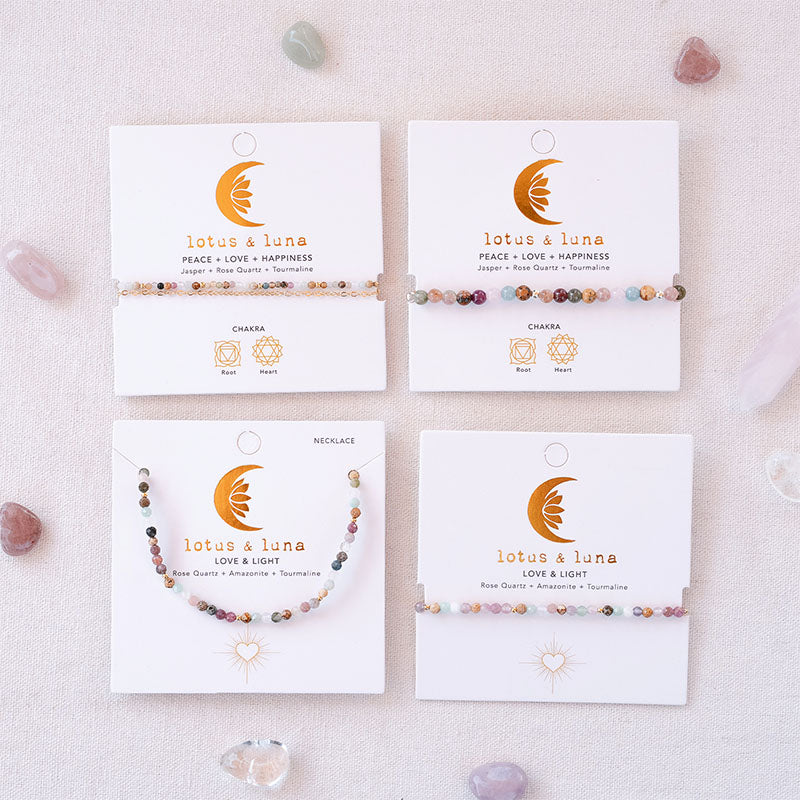 Love & Light and Peace + Love + Happiness bracelets and necklace, on brand cards
