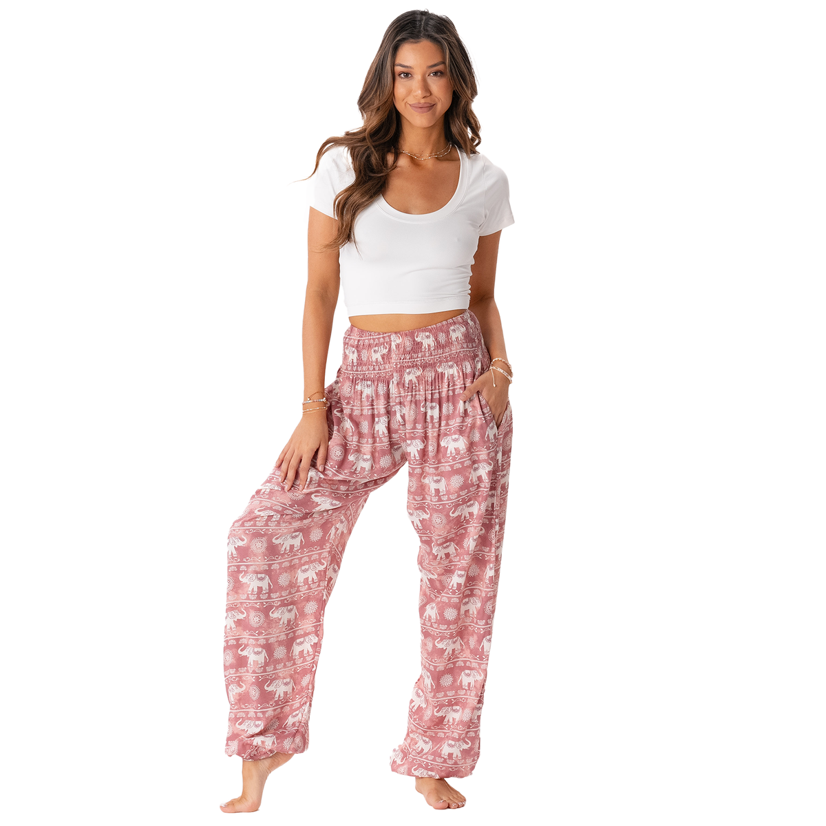 Model wearing pink harem pants with white elephant stripe pattern