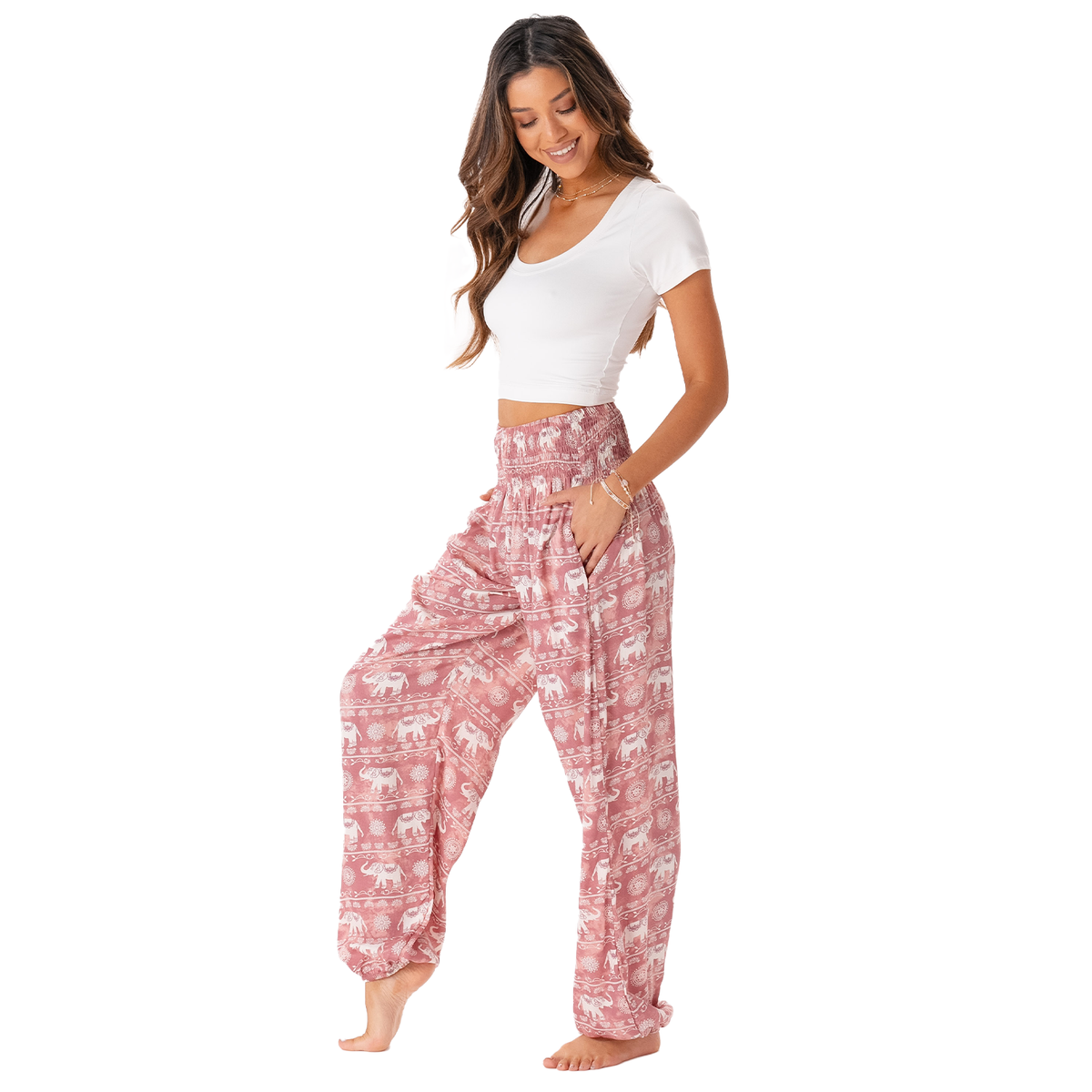 Model wearing pink harem pants with white elephant stripe pattern
