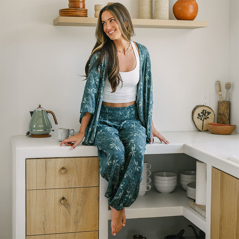 Jade Dahlia Kimono and Lounge Set, worn seated in a kitchen