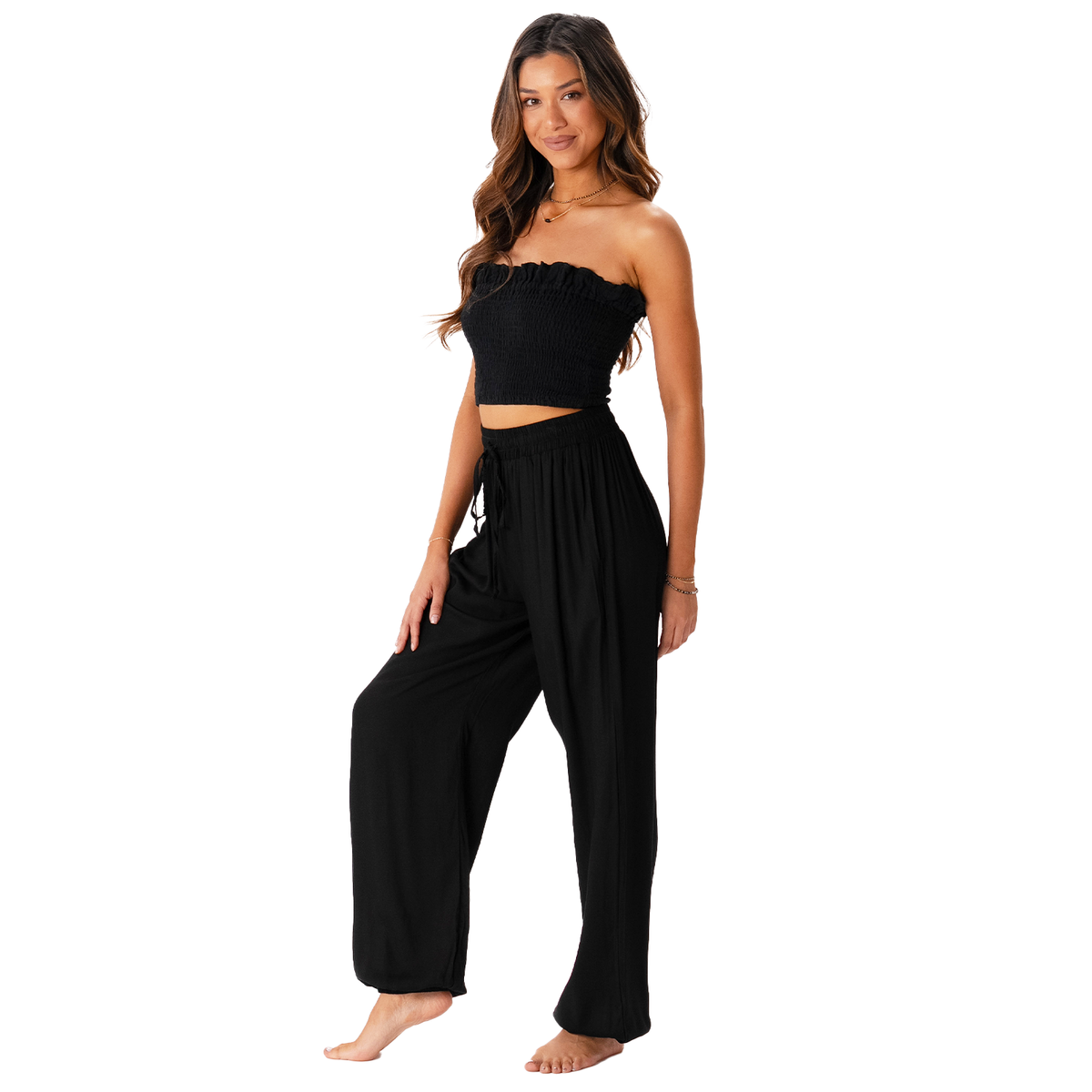 Model wearing black harem pants with a drawstring waistband with a black smocked tube top