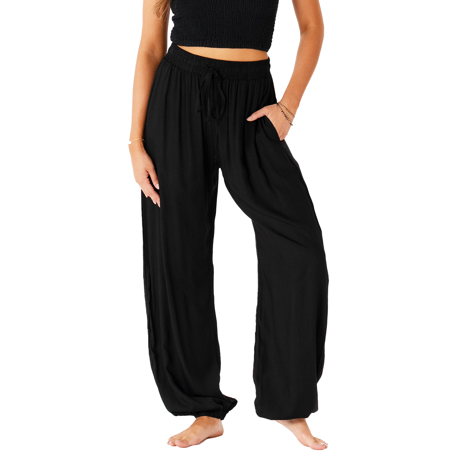 Model wearing black harem pants with a drawstring waistband