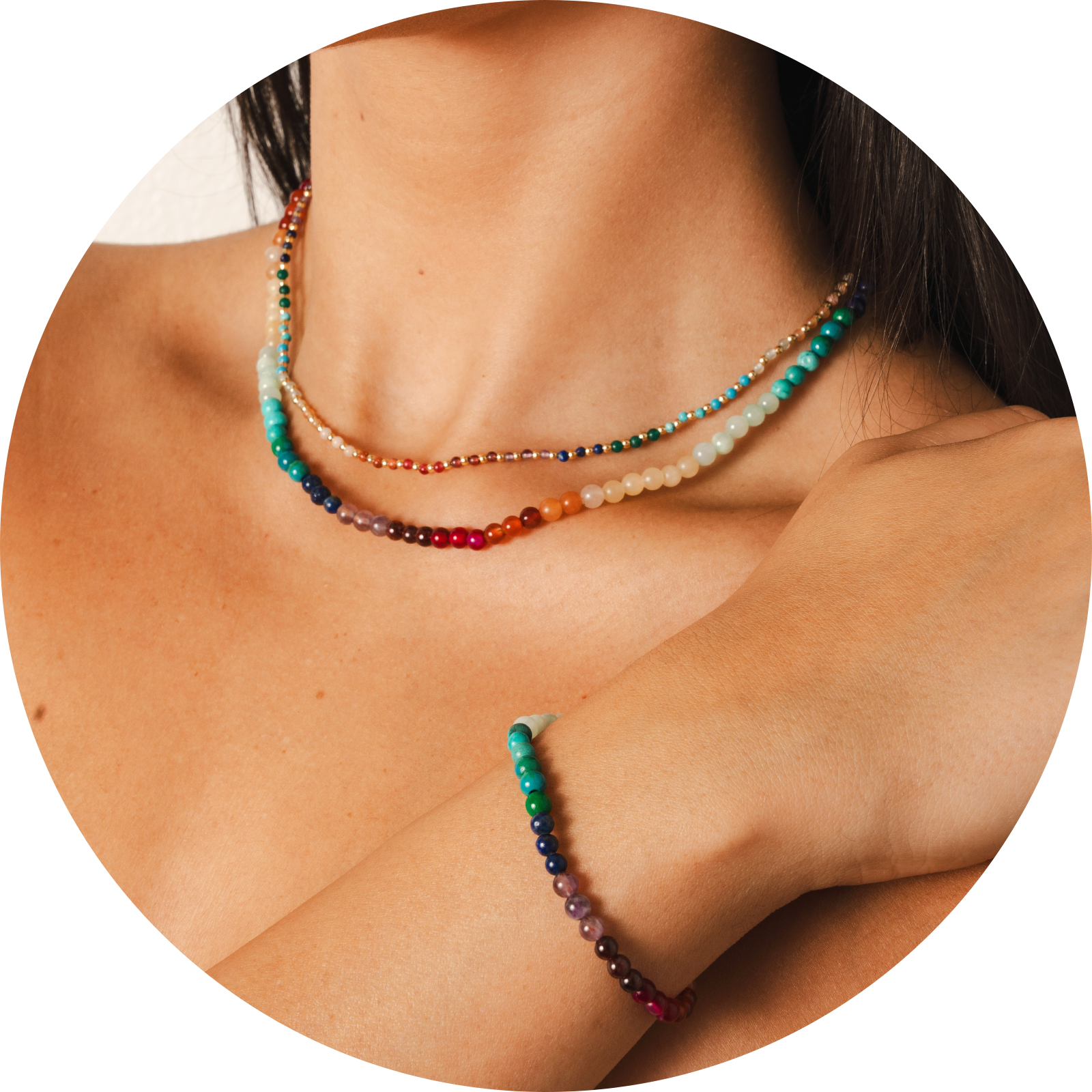 Model wearing two necklaces and a bracelet. The necklaces include a 4mm multicolor stone healing necklace and a 2mm multicolor stone and gold bead healing necklace. The bracelet is a multicolor stone healing bracelet.