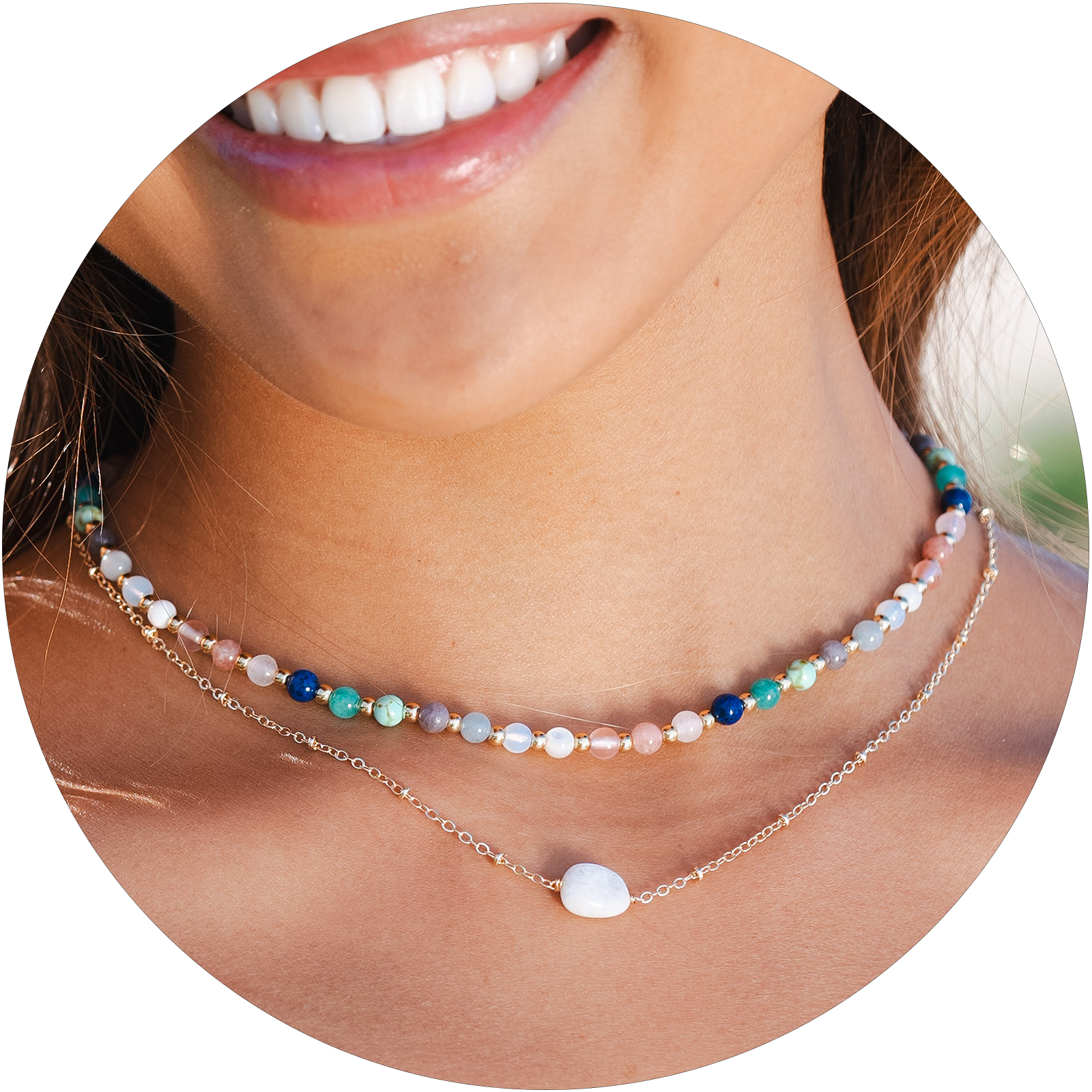 Model wearing a 4mm multicolor stone and gold bead healing necklace and a moonstone healing necklace with a gold chain.