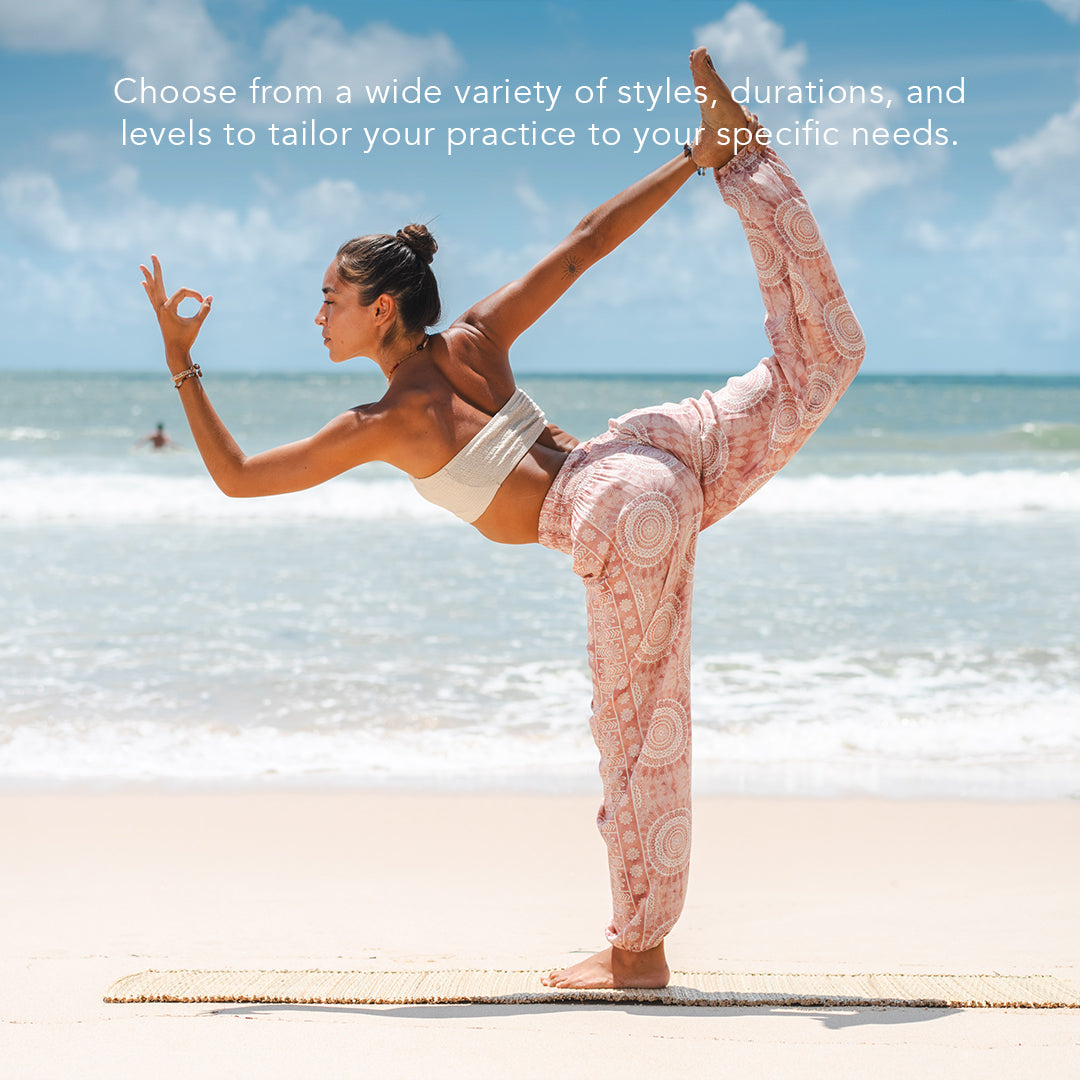 model doing yoga in pink baja harem pants on the beach