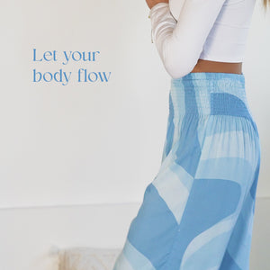 Model doing a variety of yoga poses in blue swirl harem pants